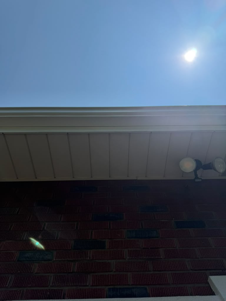 Bright soffit and gutter line after exterior cleaning