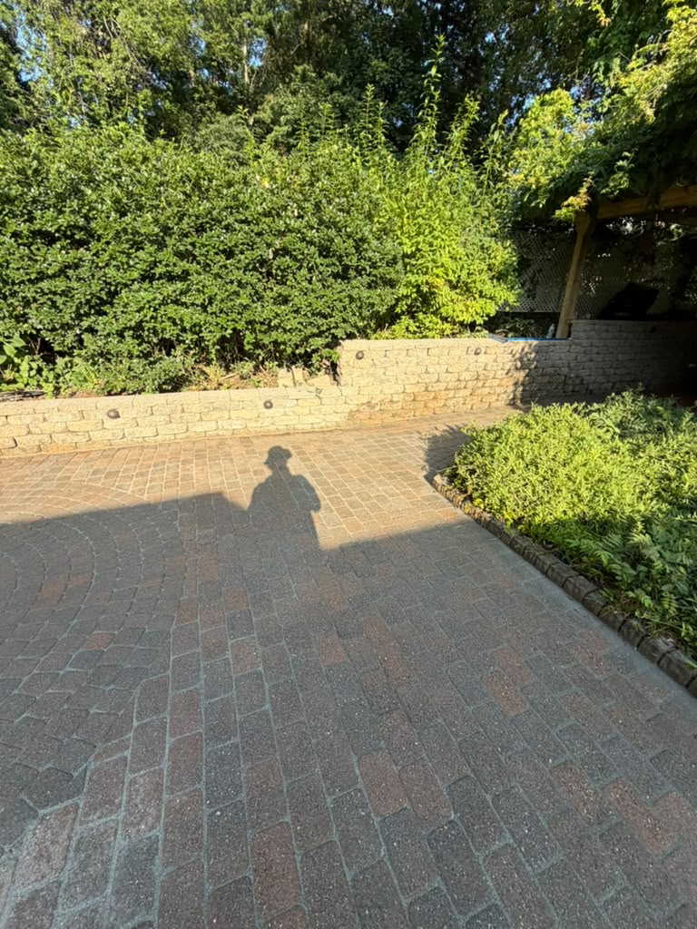 Paver patio and stone retaining wall after restoration