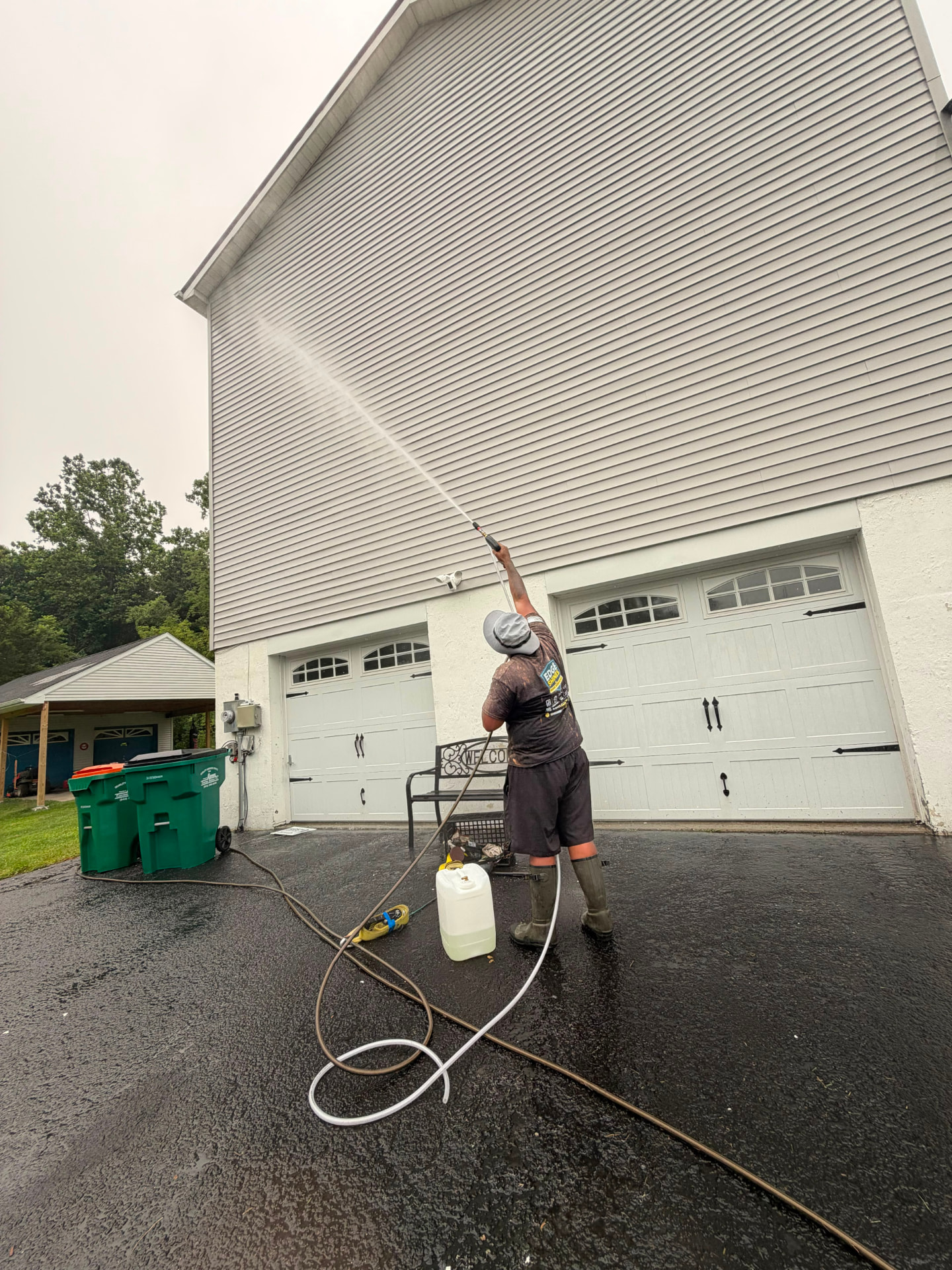 Soft washing the upper siding of a two story home
